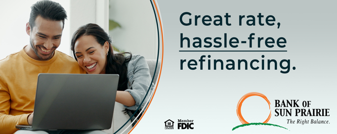 male and female looking at laptop smiling